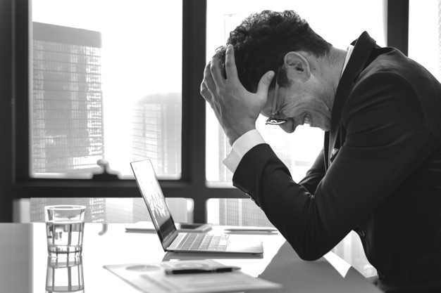 Stressed young businessman overworking